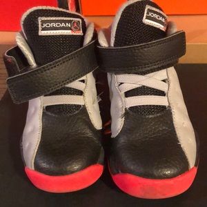 Jordan’s black gray and reddish orange size 9C.